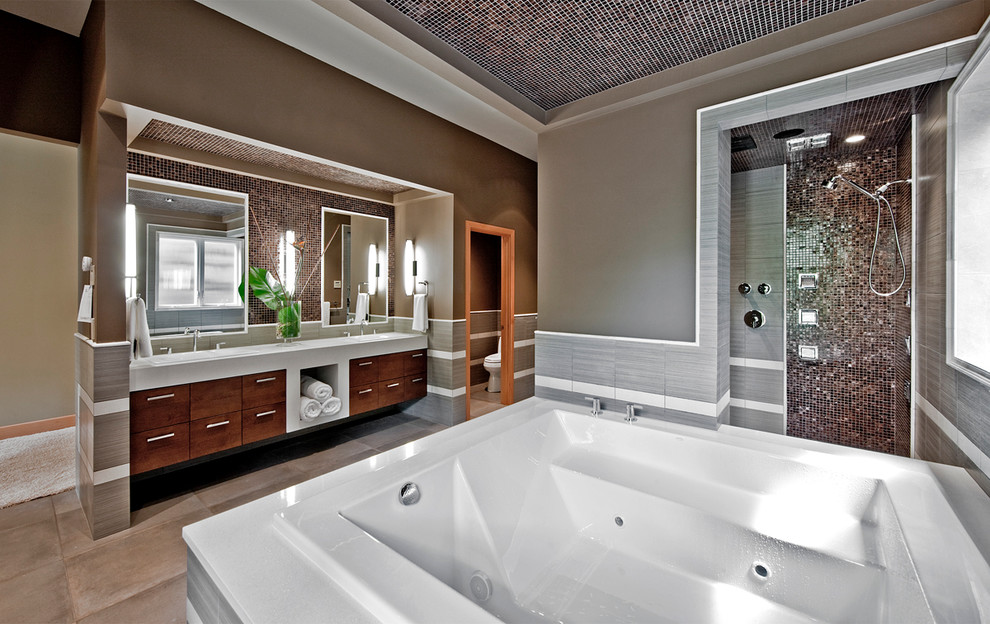 Inspiration for a contemporary master bathroom in Denver with mosaic tile, an open shower, a drop-in sink, flat-panel cabinets, medium wood cabinets, a hot tub, gray tile, brown walls, ceramic floors and an open shower.