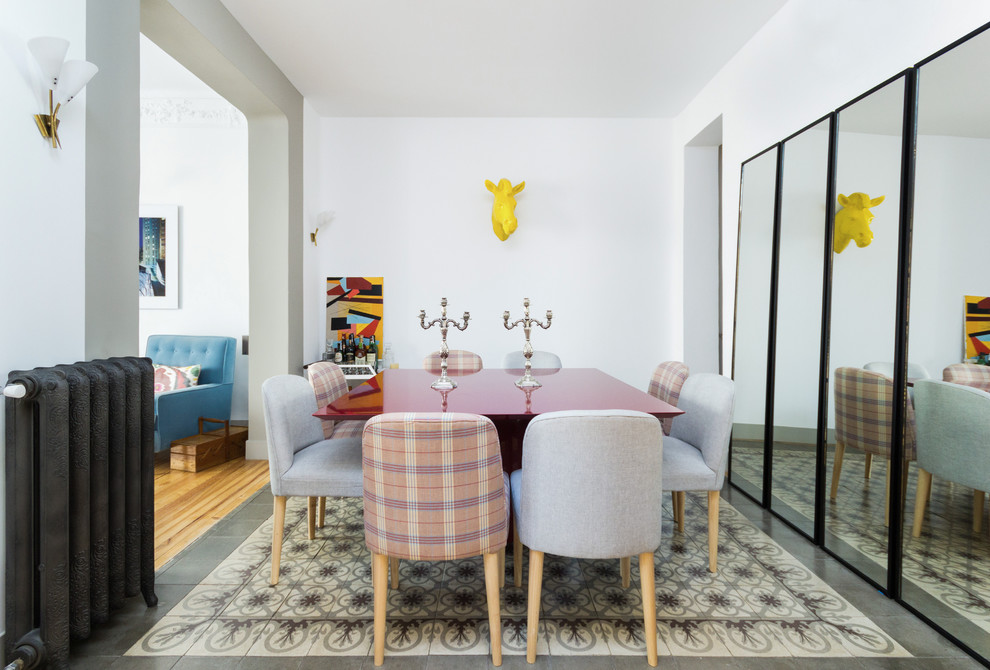 Photo of a mid-sized contemporary separate dining room in New York with white walls, ceramic floors, no fireplace and multi-coloured floor.
