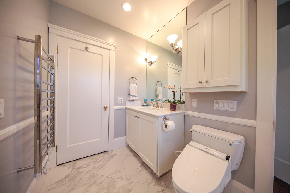Design ideas for a mid-sized traditional master bathroom in San Francisco with recessed-panel cabinets, white cabinets, a drop-in tub, a shower/bathtub combo, a bidet, white tile, white walls, linoleum floors and a pedestal sink.