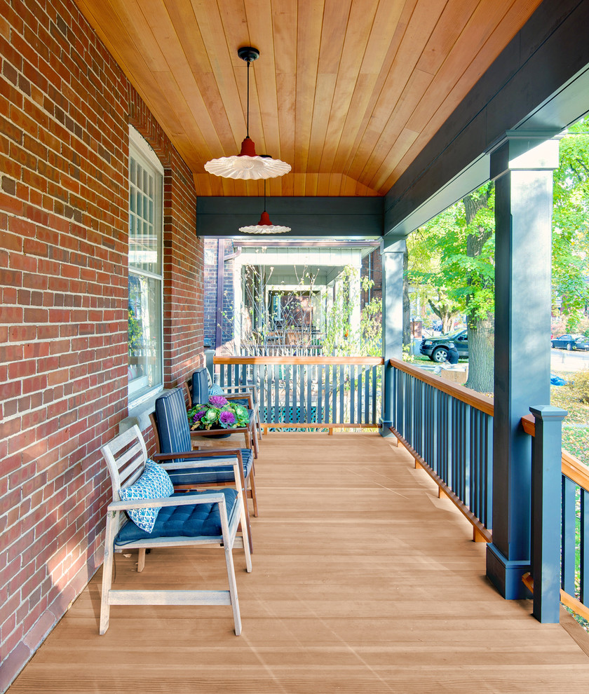 Photo of a large traditional front yard verandah in Toronto with decking and a roof extension.