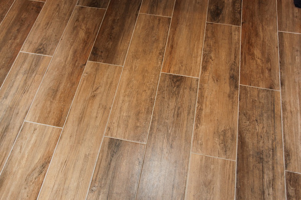 Large mountain style master slate tile brown floor home design photo in Indianapolis with brown cabinets, beige walls and an undermount sink