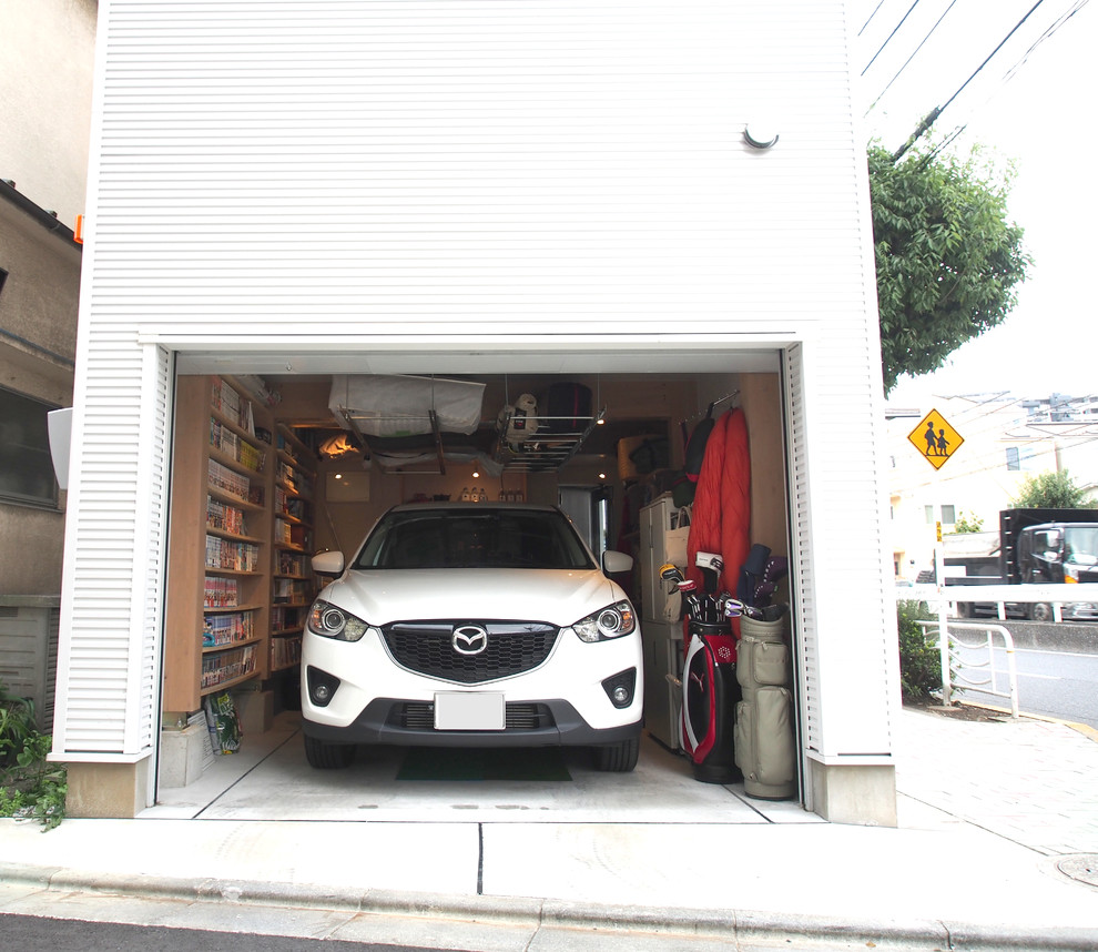 Photo of an eclectic attached one-car carport in Tokyo.