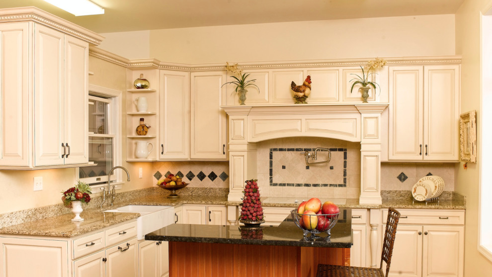Kitchen - mid-sized transitional l-shaped dark wood floor kitchen idea with a farmhouse sink, raised-panel cabinets, white cabinets, white backsplash, paneled appliances and an island