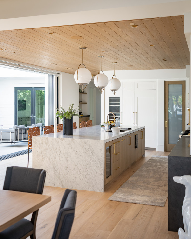 Huge transitional light wood floor kitchen photo in Orange County with an undermount sink, quartzite countertops, mosaic tile backsplash and an island