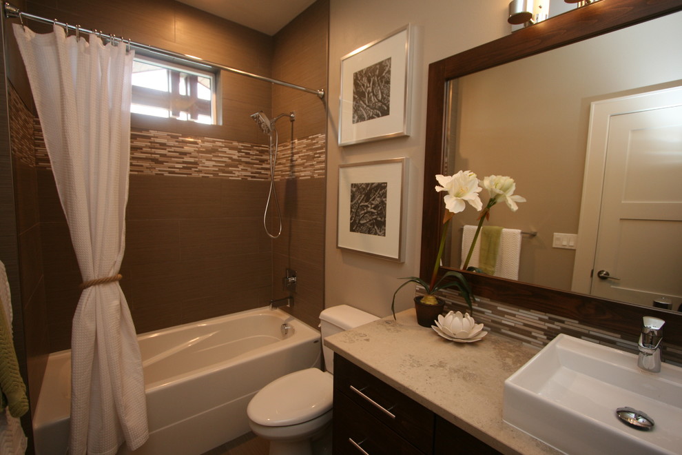 This is an example of a small contemporary bathroom in Seattle with a vessel sink, shaker cabinets, dark wood cabinets, limestone benchtops, beige tile, stone tile, grey walls, porcelain floors and an alcove tub.