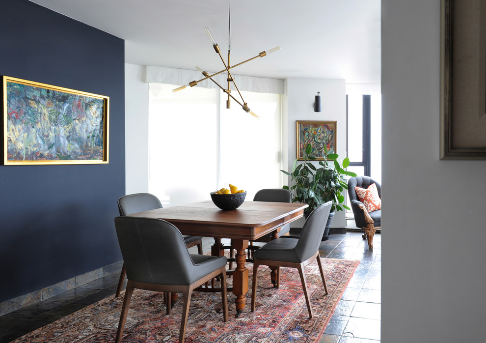 This is an example of a small transitional open plan dining in Vancouver with white walls and slate floors.