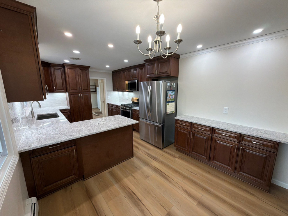 USCD cabinetry accompanied granite countertops, porcelain tile backsplash and Ca