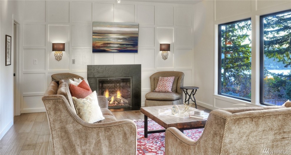 Photo of a large contemporary enclosed living room in Seattle with white walls, dark hardwood floors, a standard fireplace, a tile fireplace surround and no tv.