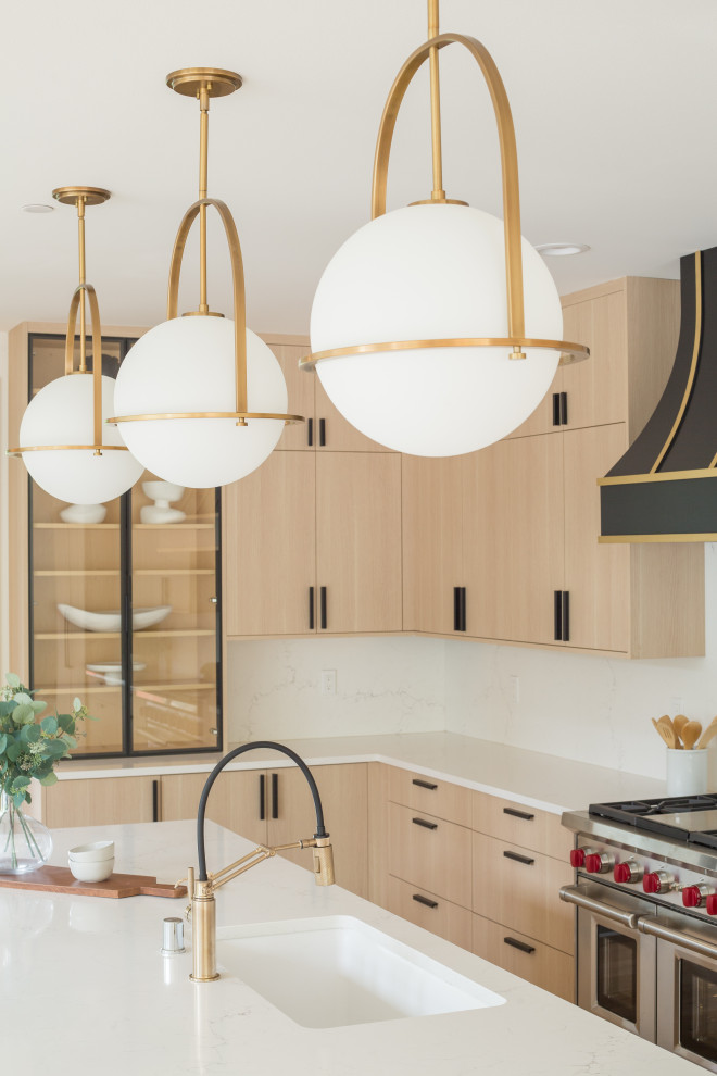 Open concept kitchen - large modern l-shaped light wood floor and brown floor open concept kitchen idea in Seattle with an undermount sink, flat-panel cabinets, light wood cabinets, quartz countertops, white backsplash, quartz backsplash, paneled appliances, an island and white countertops