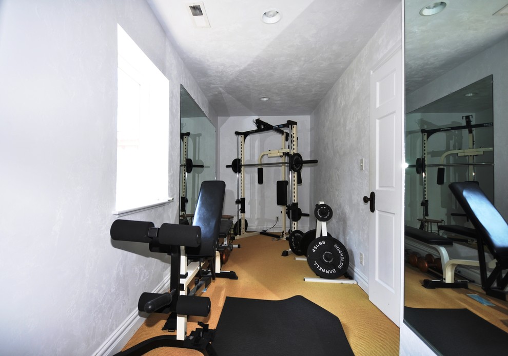 Inspiration for a mid-sized mediterranean home weight room in Other with grey walls and carpet.