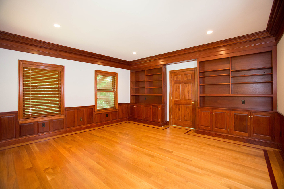 Inspiration for a traditional home office in Boston with light hardwood floors.