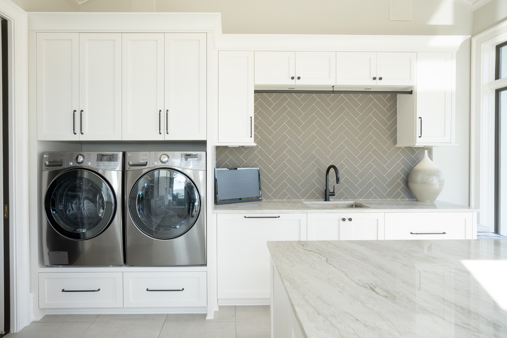 Design ideas for a transitional utility room in Other with an undermount sink, shaker cabinets, white cabinets, marble benchtops, beige walls, ceramic floors, a side-by-side washer and dryer, grey floor and green benchtop.