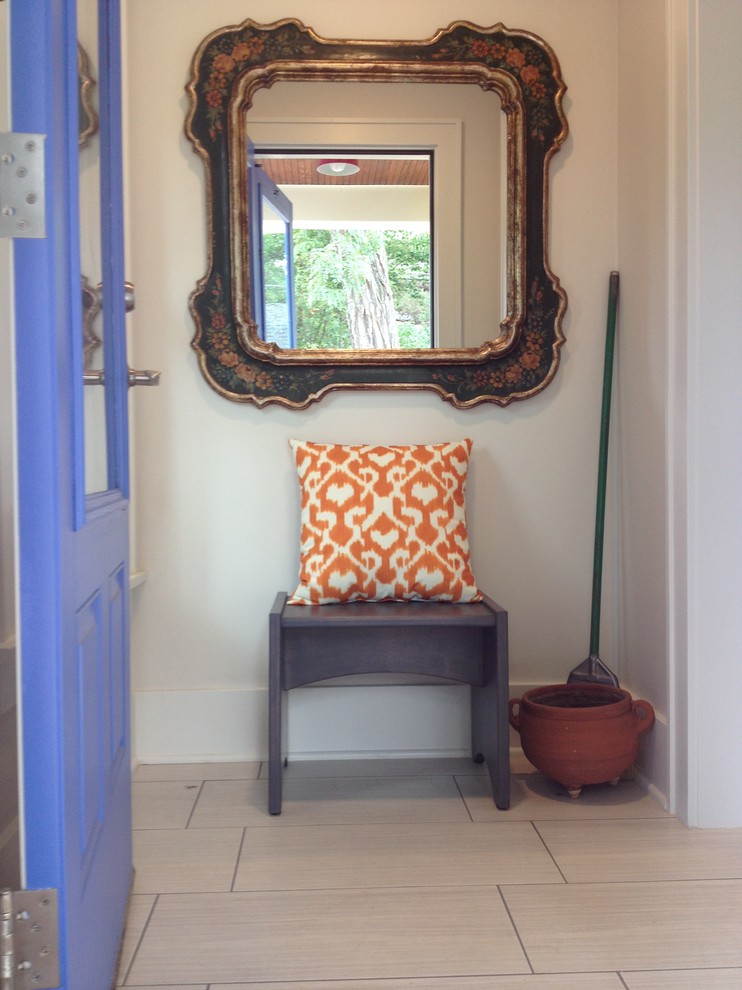 Example of a small transitional porcelain tile single front door design with white walls and a blue front door