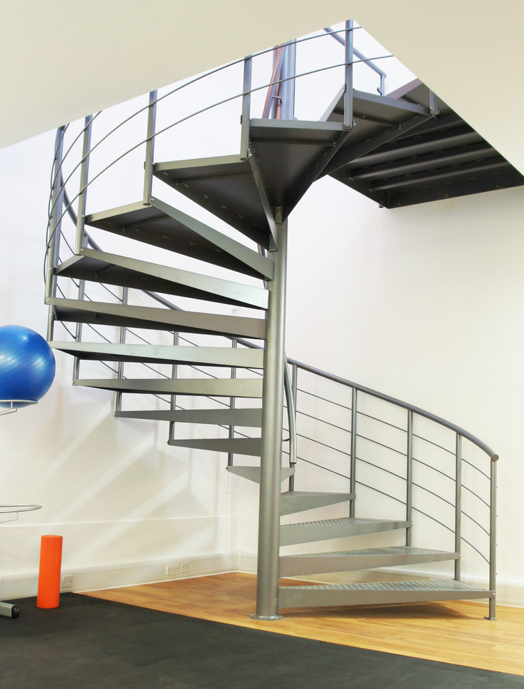 Inspiration for an expansive industrial metal spiral staircase in Hampshire with open risers.