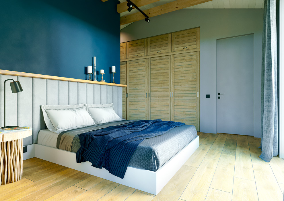 Imagen de dormitorio principal escandinavo de tamaño medio con paredes azules, suelo de baldosas de porcelana y suelo amarillo
