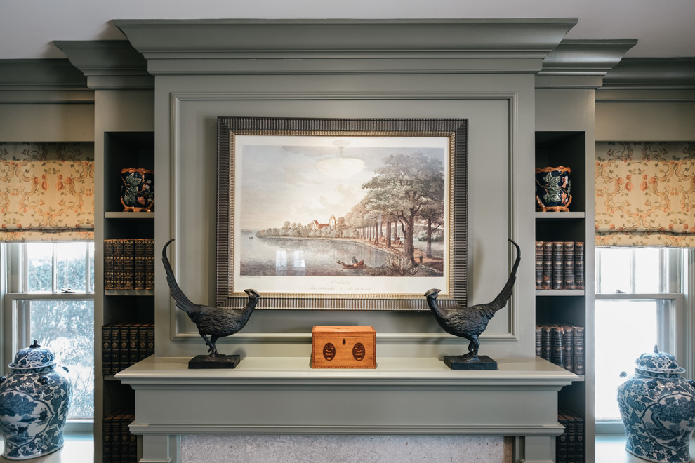 Inspiration for a mid-sized traditional study room in Minneapolis with dark hardwood floors, a standard fireplace, a wood fireplace surround, a freestanding desk and grey walls.