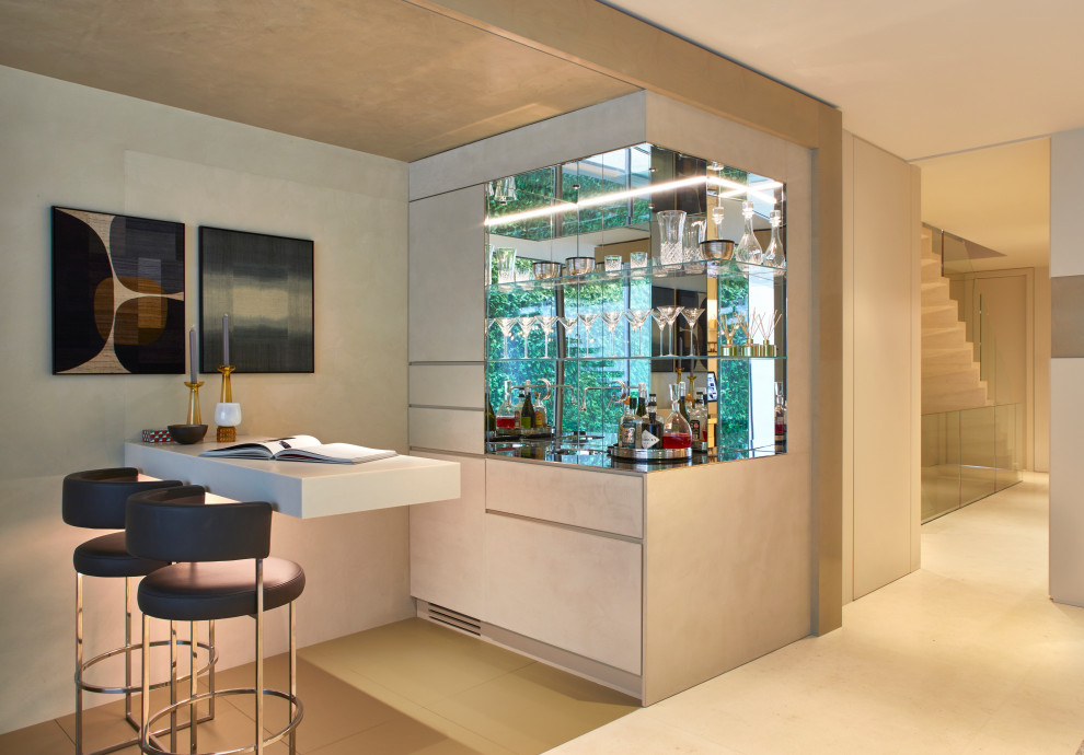 Contemporary l-shaped home bar in London with flat-panel cabinets, beige cabinets and beige floor.