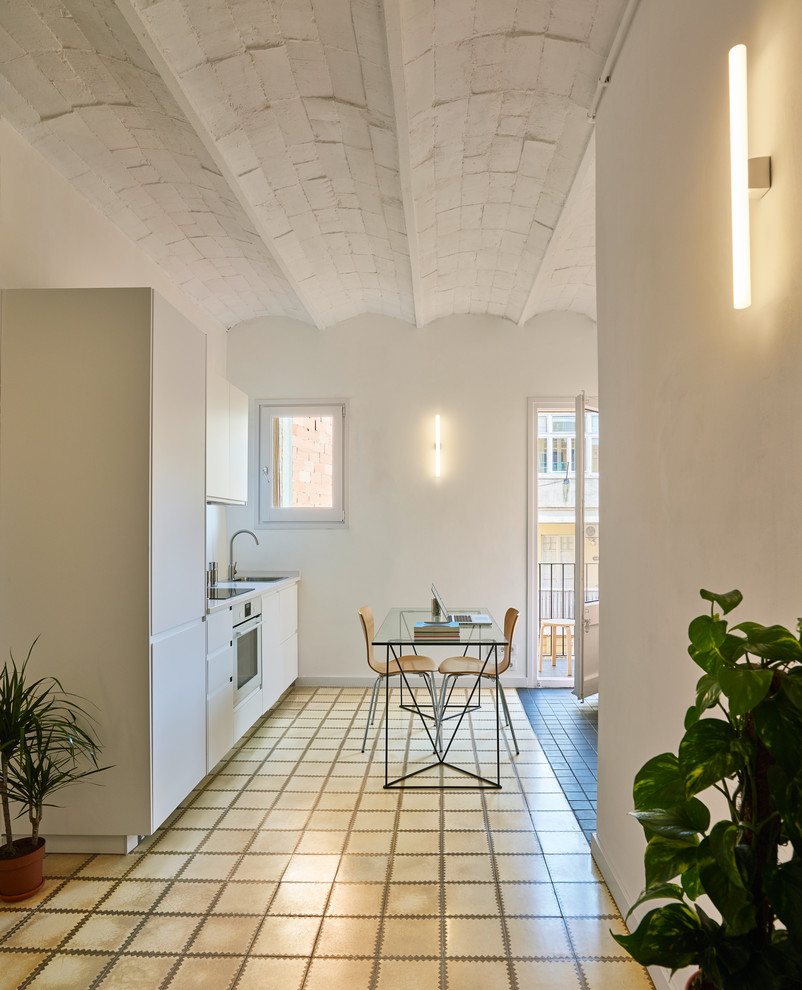 Small mediterranean single-wall eat-in kitchen in Barcelona with a single-bowl sink and ceramic floors.