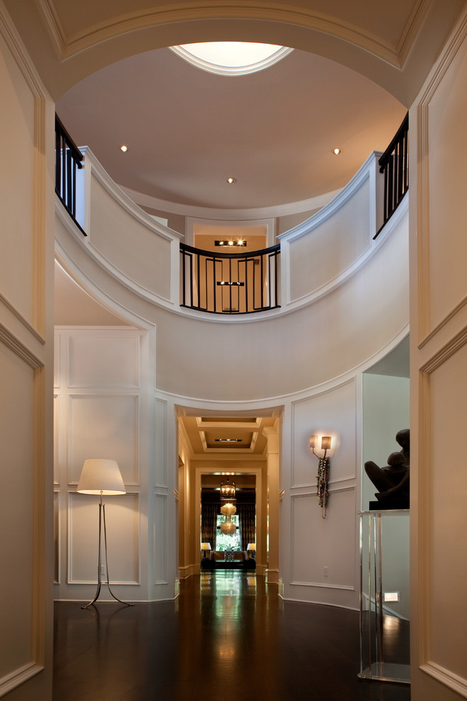 Photo of an expansive transitional foyer in Orlando with white walls and dark hardwood floors.