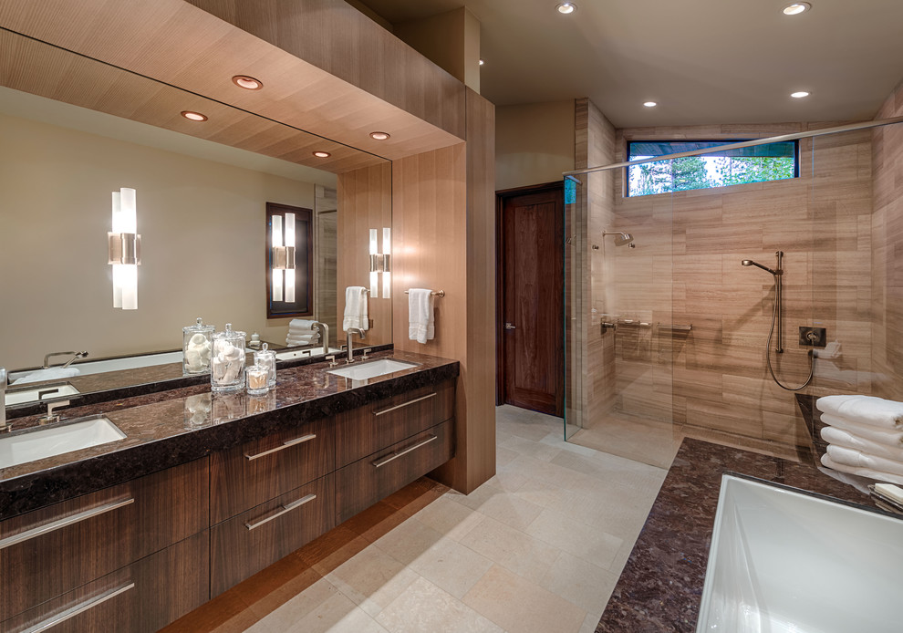 Photo of a contemporary bathroom in Sacramento with an undermount sink, flat-panel cabinets, dark wood cabinets, a curbless shower, beige tile and brown benchtops.