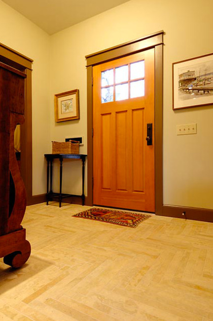Example of a small transitional limestone floor front door design in Seattle with beige walls and a brown front door