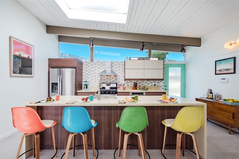 Design ideas for a mid-sized midcentury galley open plan kitchen in Los Angeles with an undermount sink, flat-panel cabinets, medium wood cabinets, quartz benchtops, multi-coloured splashback, stainless steel appliances, porcelain floors, with island, grey floor and beige benchtop.