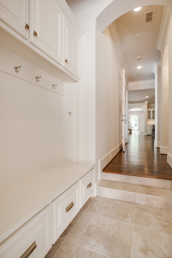 Inspiration for a traditional mudroom in Dallas with grey walls and ceramic floors.