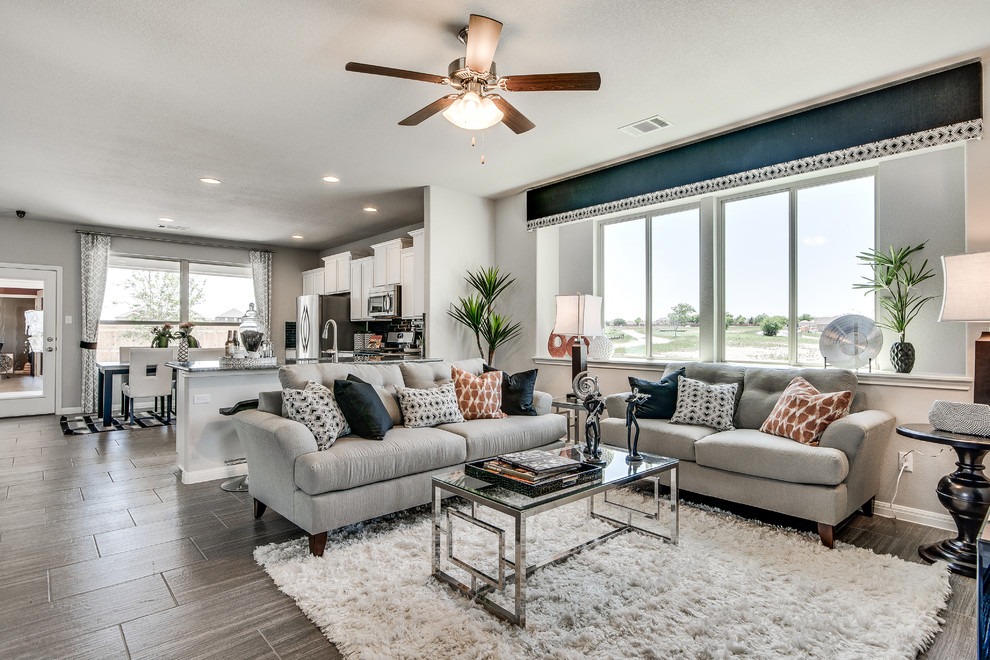 Inspiration for a transitional open concept living room in Austin with grey walls and medium hardwood floors.
