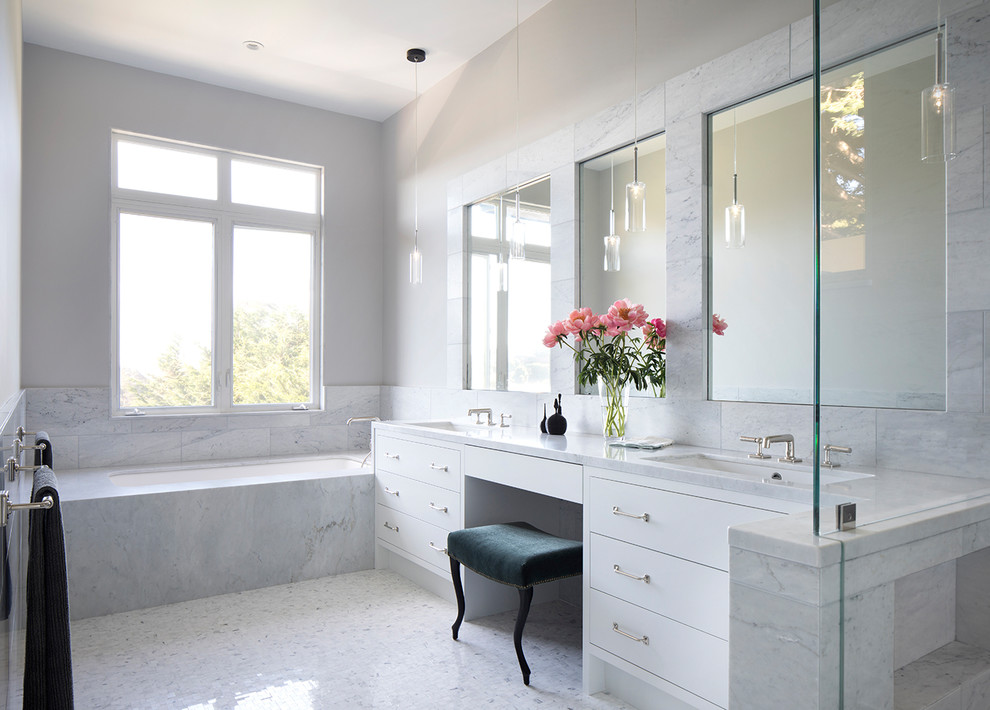 This is an example of a large contemporary master bathroom in San Francisco with flat-panel cabinets, white cabinets, a corner shower, a one-piece toilet, multi-coloured tile, stone tile, multi-coloured walls, ceramic floors, an undermount sink, soapstone benchtops, multi-coloured floor, a hinged shower door and white benchtops.