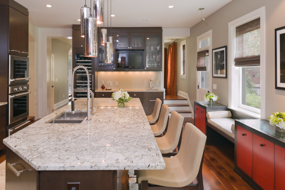 Inspiration for a large contemporary u-shaped separate kitchen in Columbus with an undermount sink, flat-panel cabinets, dark wood cabinets, marble benchtops, beige splashback, stainless steel appliances, medium hardwood floors and with island.