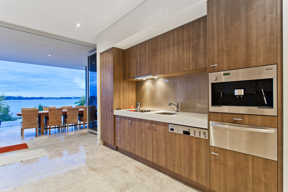 Contemporary single-wall eat-in kitchen in Perth with an undermount sink, flat-panel cabinets, dark wood cabinets, brown splashback, glass sheet splashback, stainless steel appliances and no island.