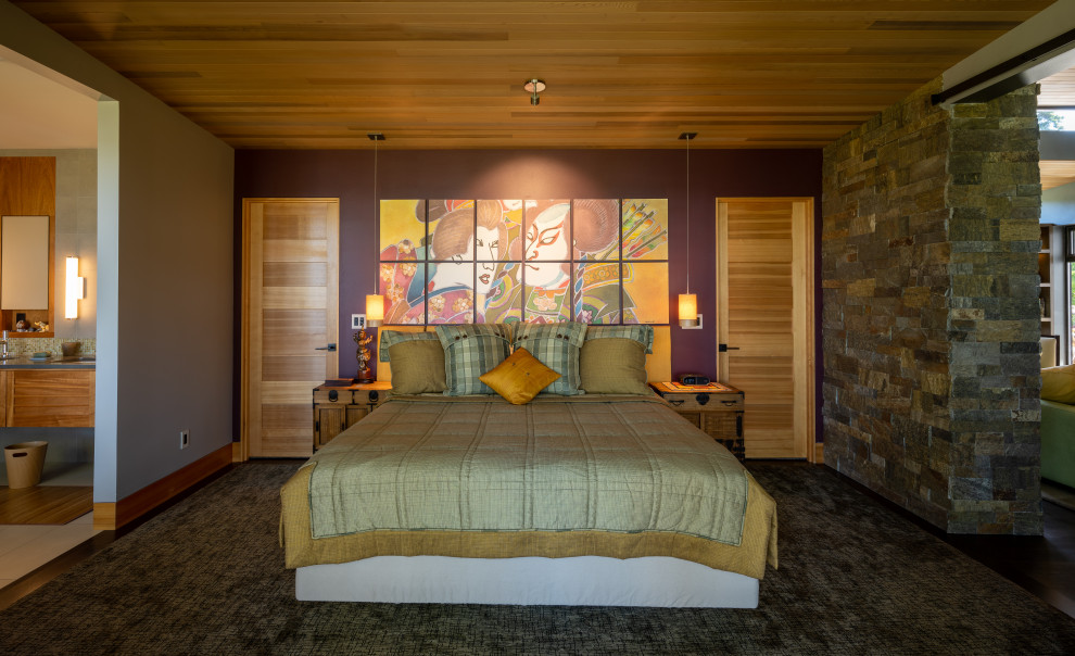 Large modern master bedroom in Seattle with blue walls, dark hardwood floors, brown floor and wood.