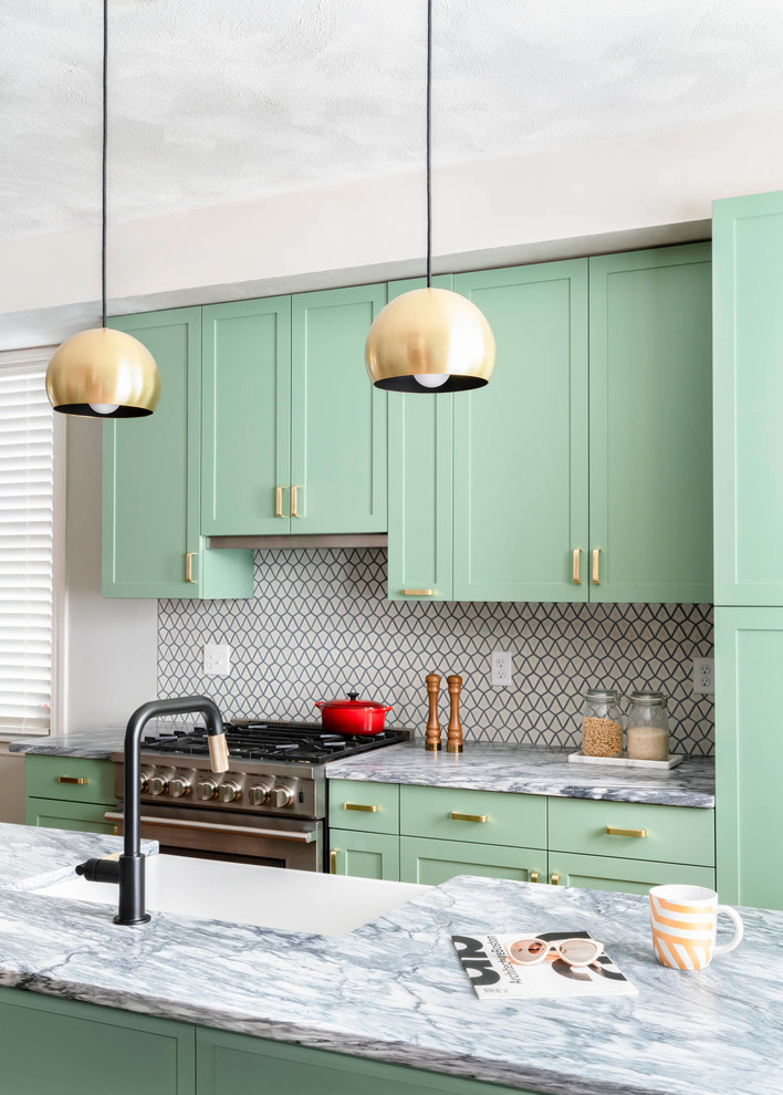 Photo of a transitional kitchen in Boston with a farmhouse sink, shaker cabinets, green cabinets, multi-coloured splashback, stainless steel appliances, with island and multi-coloured benchtop.