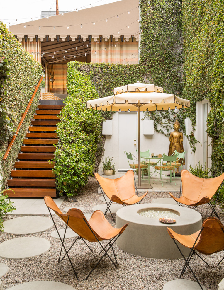 Inspiration for a mid-sized eclectic courtyard gravel patio remodel in Los Angeles with a fire pit and no cover