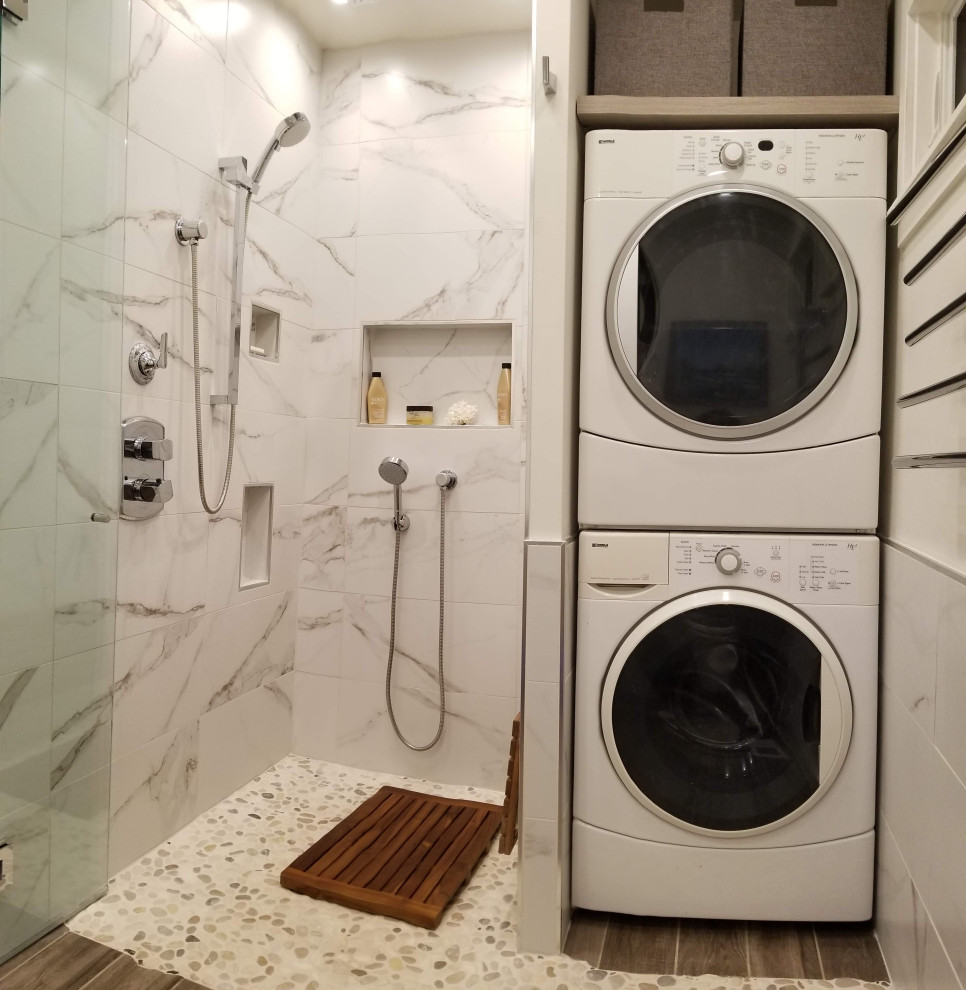 Photo of a medium sized modern utility room in Portland with white walls, a stacked washer and dryer and a vaulted ceiling.