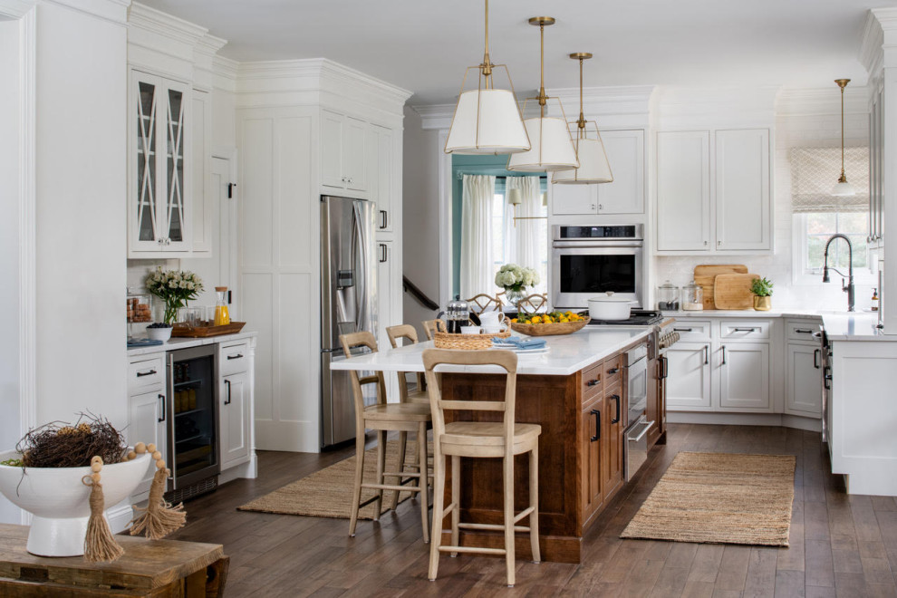 Kitchen - transitional u-shaped dark wood floor and brown floor kitchen idea with an undermount sink, beaded inset cabinets, white cabinets, stainless steel appliances, an island and white countertops