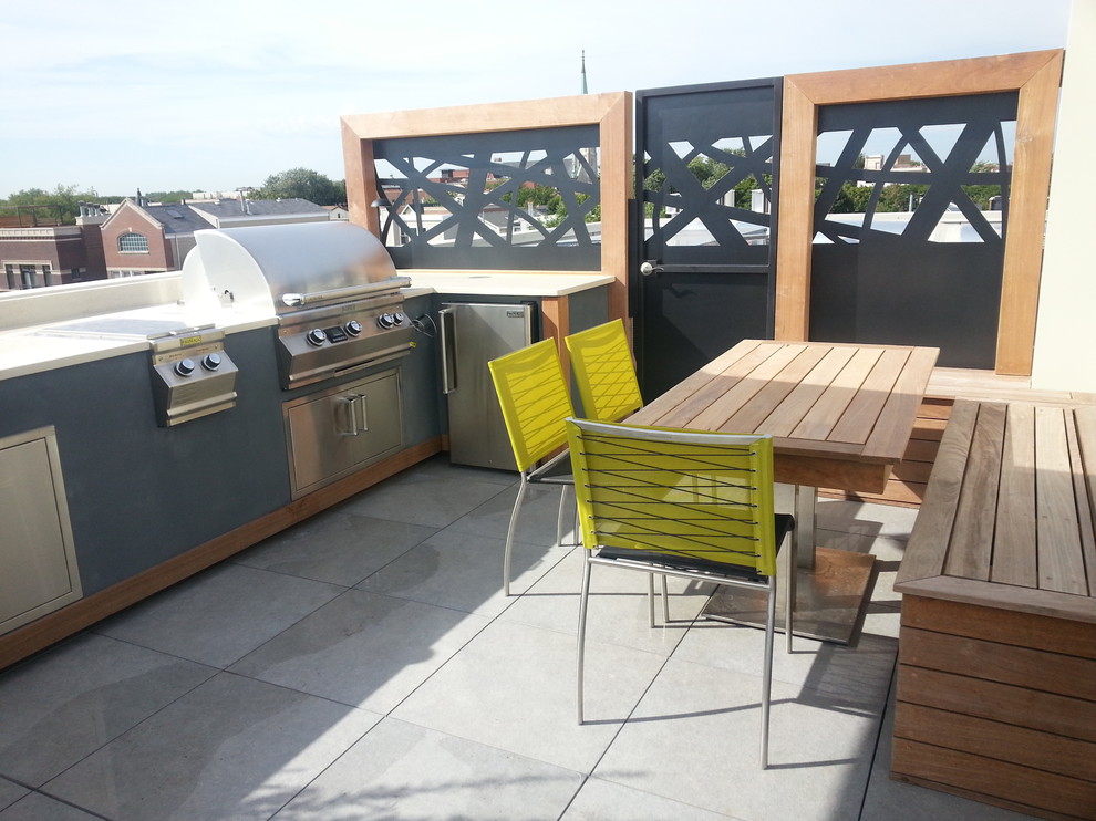 This is an example of a small modern rooftop deck in Chicago with an outdoor kitchen and no cover.