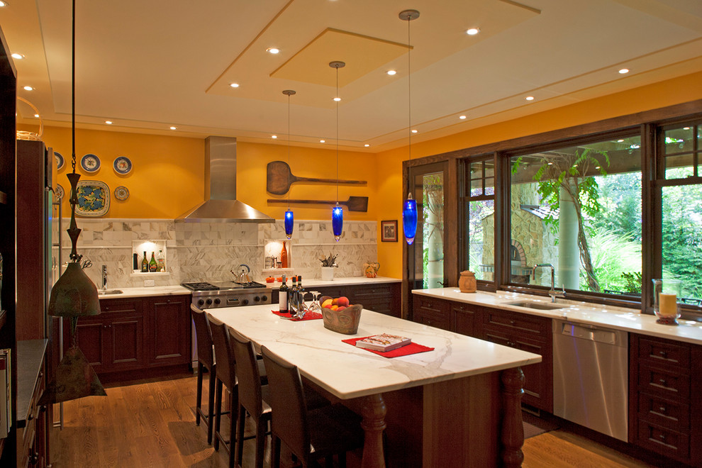 Photo of a contemporary kitchen in New York with stainless steel appliances and marble benchtops.
