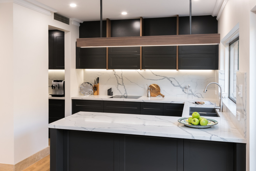 Mid-sized contemporary u-shaped open plan kitchen in Adelaide with a double-bowl sink, shaker cabinets, grey cabinets, quartz benchtops, white splashback, stone slab splashback, stainless steel appliances, light hardwood floors, a peninsula and white benchtop.
