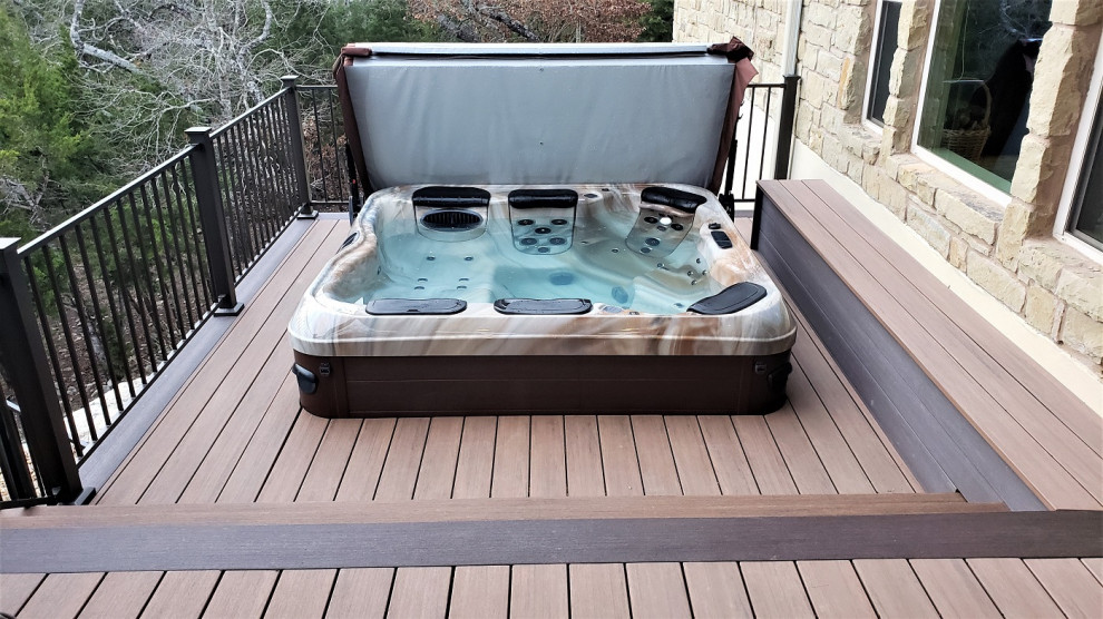 Deck - large rustic backyard second story metal railing deck idea in Austin with a roof extension