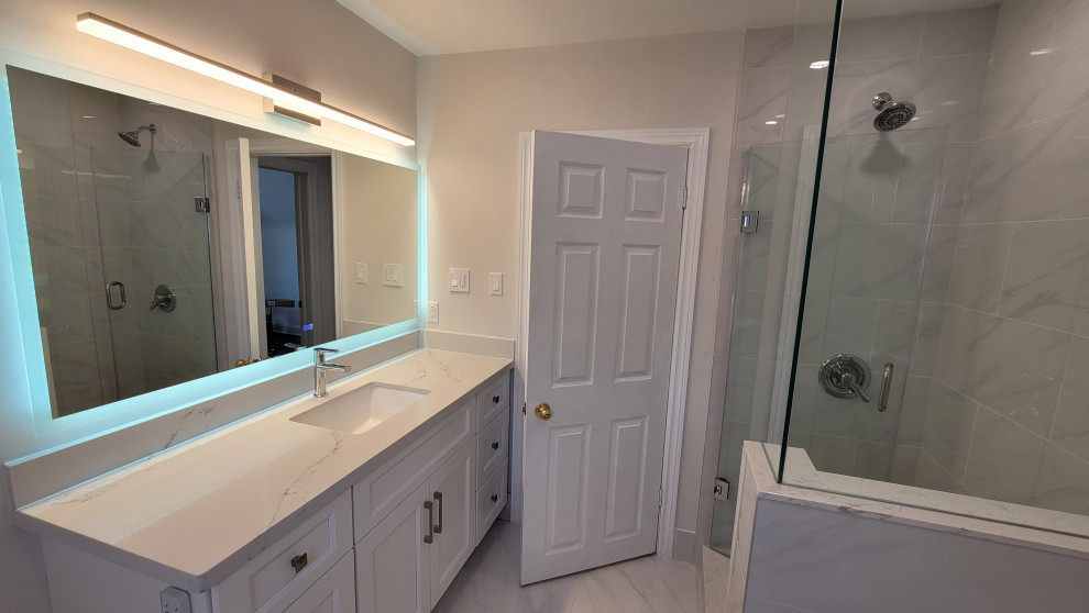 This is an example of a small classic shower room bathroom in Toronto with recessed-panel cabinets, white cabinets, a corner shower, white tiles, porcelain tiles, white walls, porcelain flooring, a submerged sink, engineered stone worktops, white floors, a hinged door, white worktops, a single sink and a freestanding vanity unit.