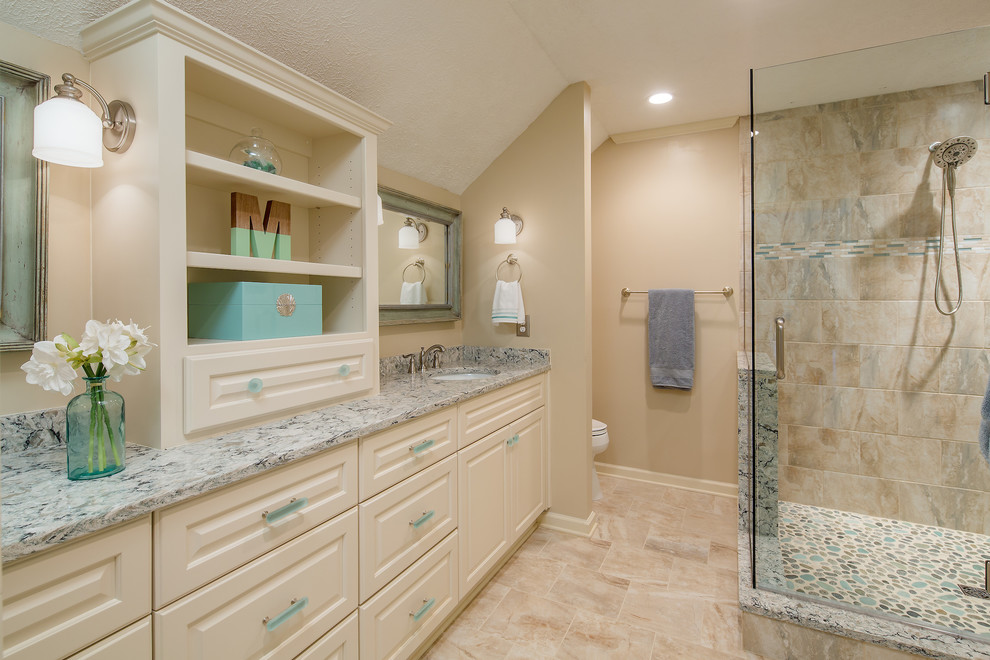 Photo of a mid-sized traditional master bathroom in Atlanta with raised-panel cabinets, white cabinets, an alcove shower, a two-piece toilet, beige walls, travertine floors, an undermount sink and engineered quartz benchtops.