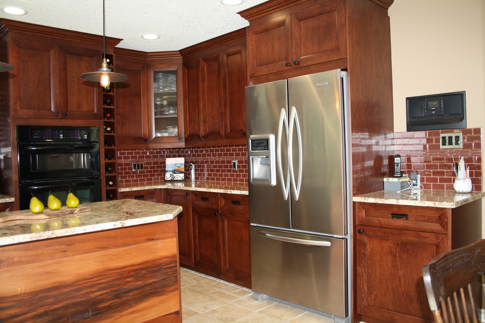 Example of a mid-sized transitional u-shaped ceramic tile eat-in kitchen design in Edmonton with an undermount sink, flat-panel cabinets, brown cabinets, granite countertops, red backsplash, subway tile backsplash, stainless steel appliances and an island