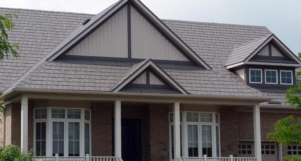 Example of a mid-sized transitional brown two-story brick house exterior design in Austin with a hip roof and a shingle roof