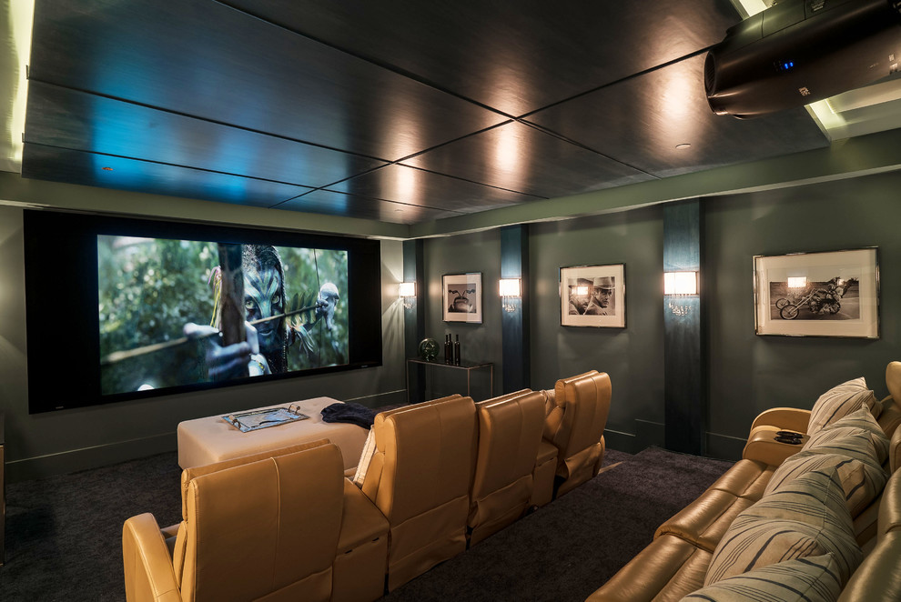 Photo of a large beach style enclosed home theatre in Los Angeles with carpet, a projector screen, green walls and brown floor.
