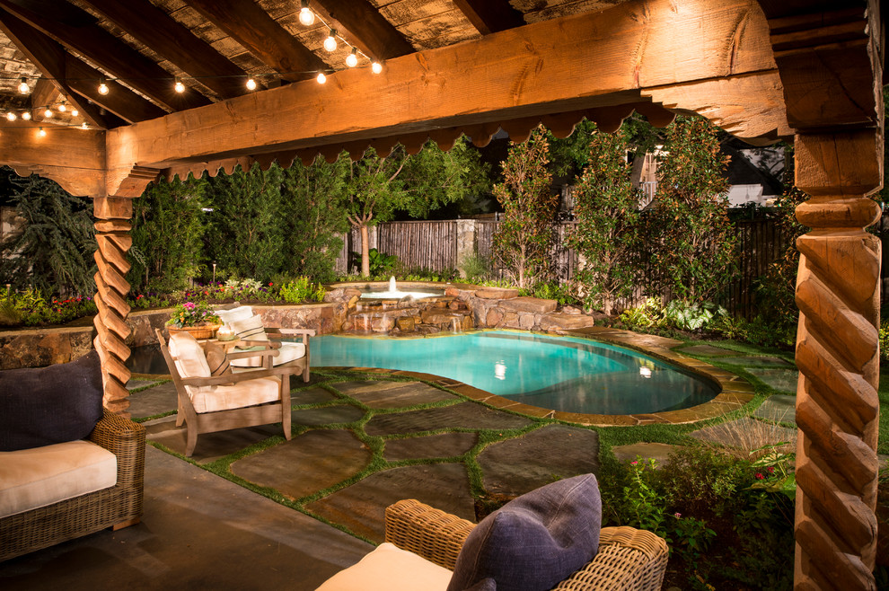 Large eclectic backyard custom-shaped natural pool in Dallas with a hot tub and natural stone pavers.