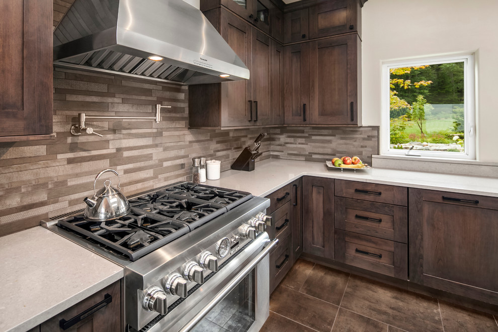 Inspiration for a mid-sized transitional l-shaped separate kitchen in Phoenix with an undermount sink, shaker cabinets, dark wood cabinets, quartz benchtops, beige splashback, stone tile splashback, stainless steel appliances, porcelain floors and with island.