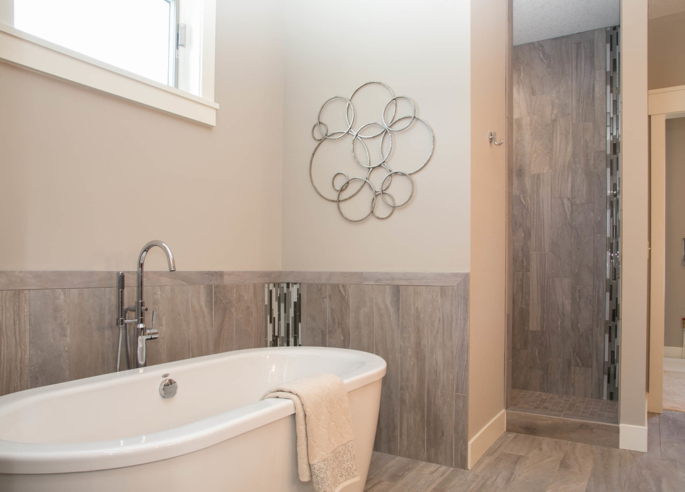 Large transitional master bathroom in Minneapolis with a freestanding tub, an open shower, gray tile, porcelain tile, grey walls, porcelain floors, an undermount sink, flat-panel cabinets, dark wood cabinets, granite benchtops and a two-piece toilet.