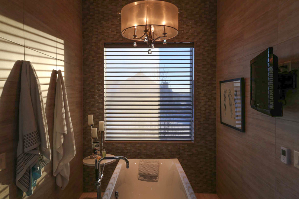 Large transitional master beige tile and porcelain tile porcelain tile and beige floor freestanding bathtub photo with shaker cabinets, black cabinets, a two-piece toilet, beige walls, a vessel sink, quartzite countertops, a hinged shower door and black countertops