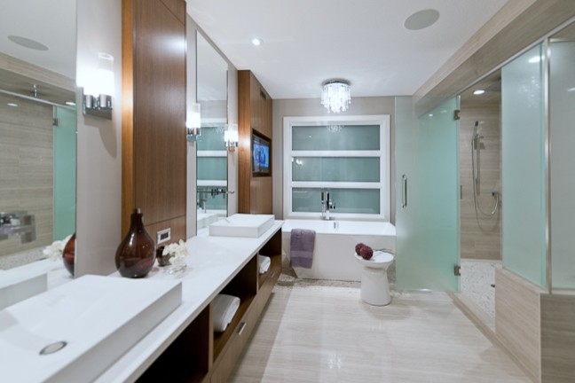This is an example of an expansive contemporary 3/4 bathroom in Other with medium wood cabinets, a freestanding tub, a double shower, a one-piece toilet, gray tile, pebble tile, beige walls, pebble tile floors, a vessel sink and granite benchtops.